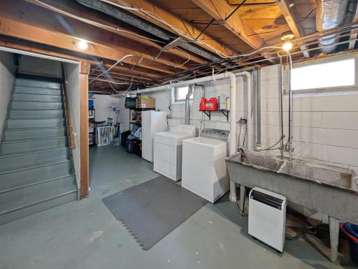 Laundry and additional storage under the steps.