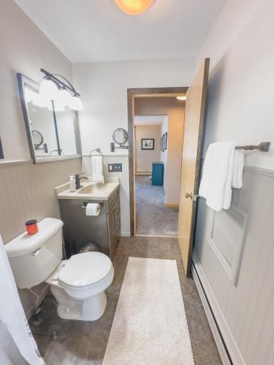 Reverse view highlighting vanity, mirror, and hallway access.