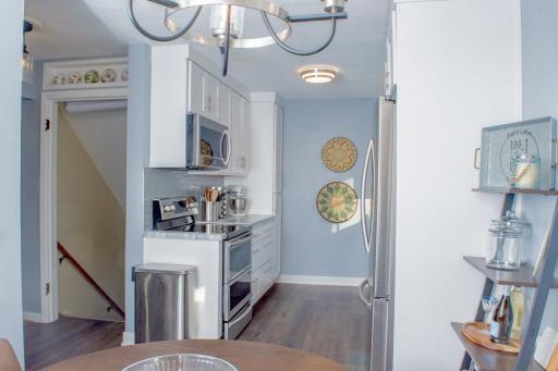 View of the kitchen with nearby stair access and open sightlines to adjacent living space.