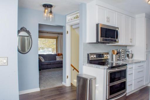 Alternate kitchen perspective showing appliance layout and flow toward the living area.