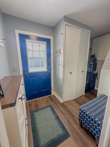Rear entry space with exterior access, storage cabinetry, and durable flooring suitable for everyday use.