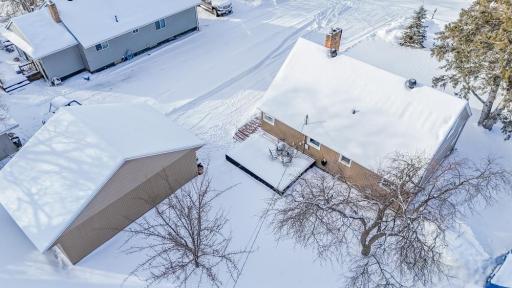 6. **Rear Yard** – Open backyard with grass lawn and surrounding trees, providing flexible outdoor space.