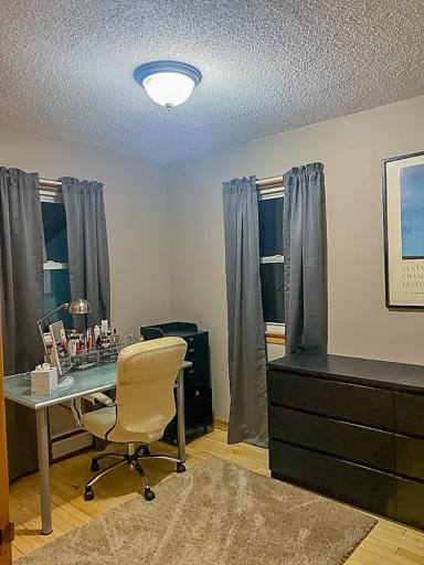 Bedroom or flex space with wood flooring, window, and room for furnishings or workspace.