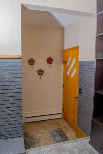 Front entry area with tile flooring, exterior door access, and transition into the main living space.