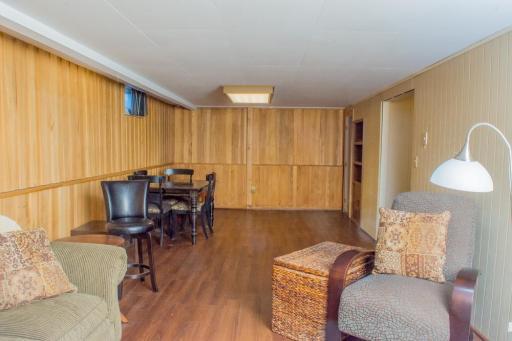 Additional view of the finished lower level highlighting paneled walls and open layout suitable for multiple uses.