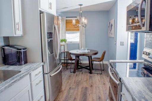 Dining space adjacent to the kitchen with room for a table and window providing natural light.