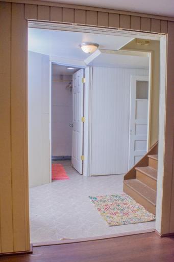 Stairway connecting the main and lower levels with adjacent hallway access.