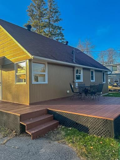 **Rear Exterior / Deck** – Wood deck with step access provides space for outdoor seating and everyday use, located directly off the rear of the home.