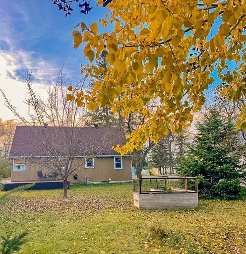 **Backyard Garden Area** – Raised garden beds situated in the yard, suitable for seasonal planting or outdoor projects.