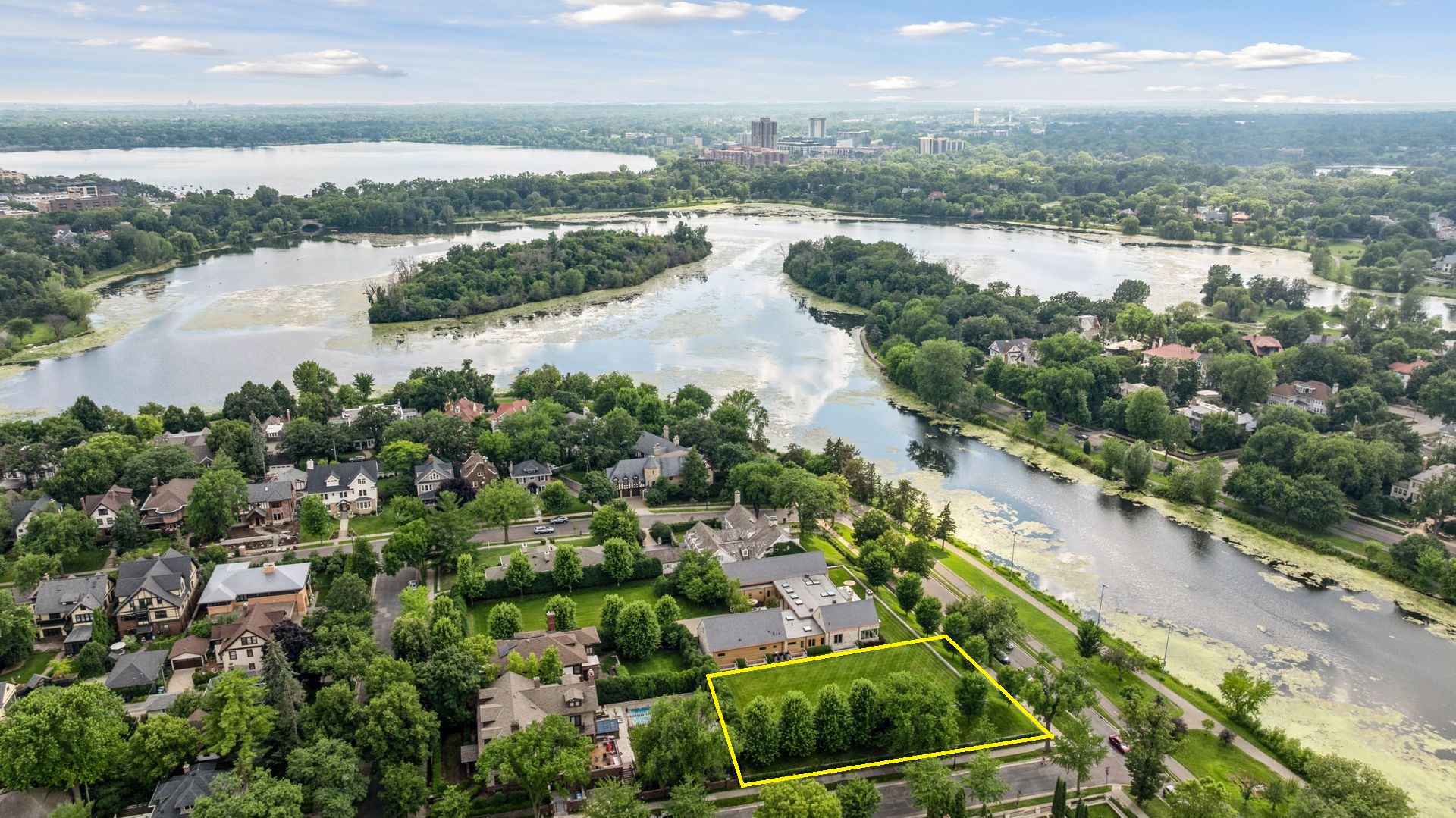2501 East Lake of the Isles Parkway. The yellow outline on photo highlights the approximate boundaries (90x186x90x178) of the vacant lot.