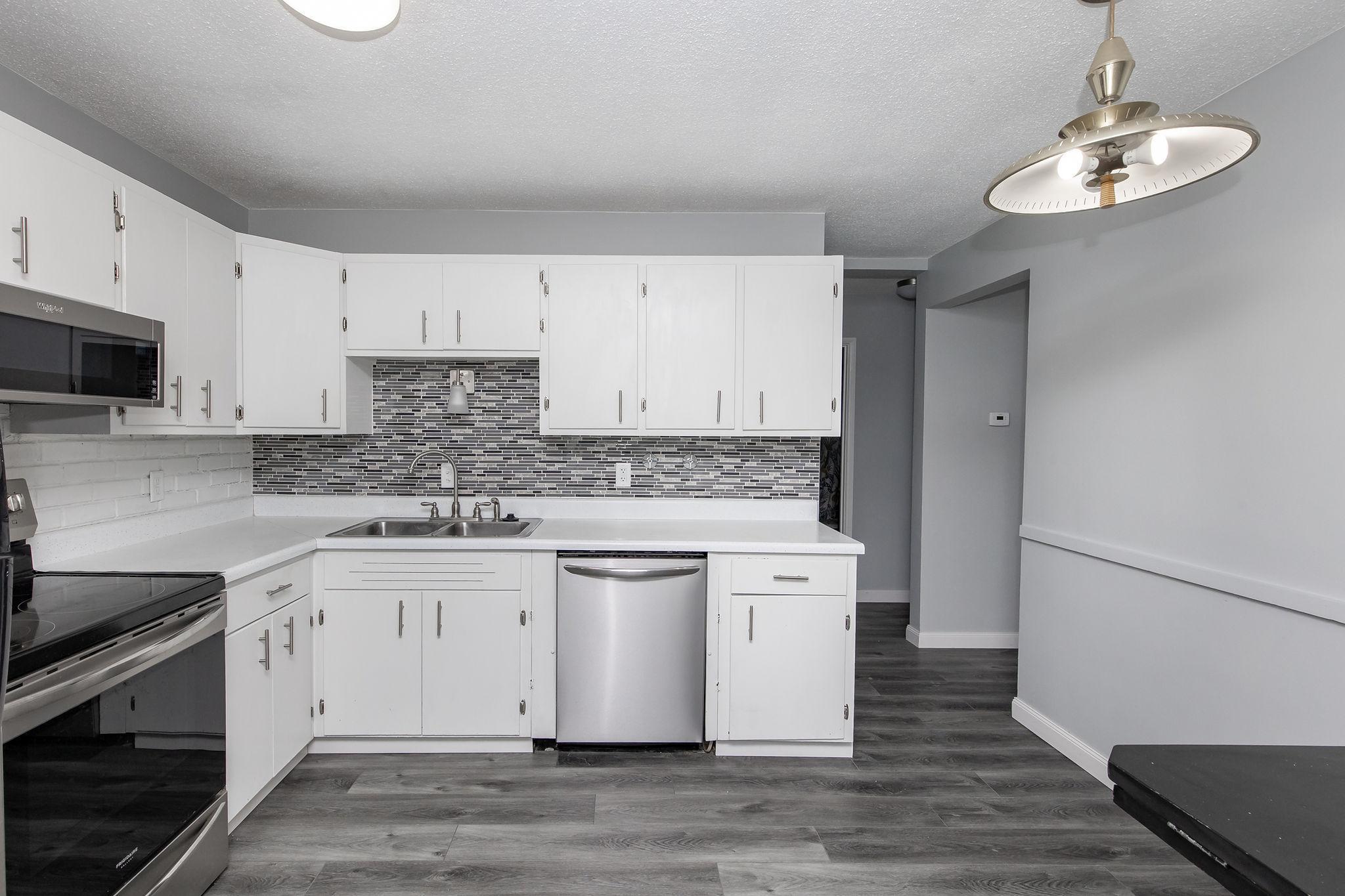 Kitchen w/ entry to living room