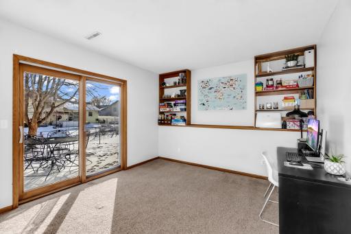 grand lower level family room with walk out to private patio and fenced back yard