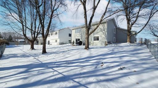 fenced backyard with mature trees