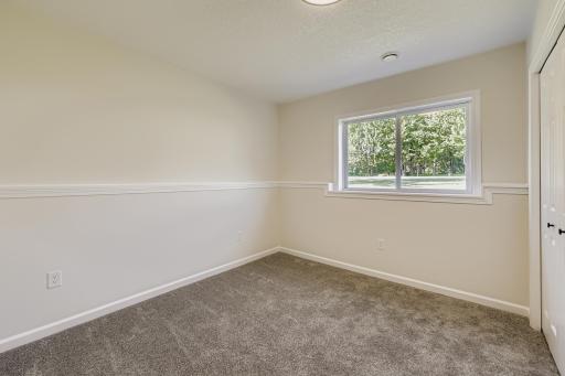 Lower-level bedroom with backyard view.