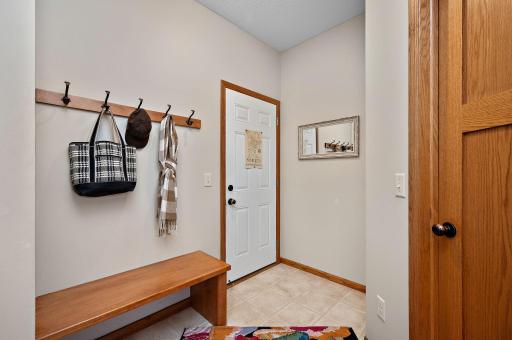 Roomy mud room with bench and large walk in closet.