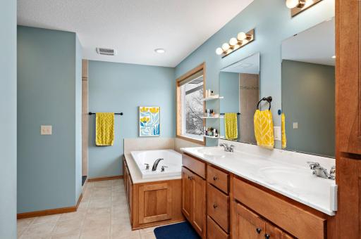 Ensuite bath with double sinks, plentiful cabinets and xtra long jetted tub.