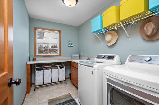 Make work less work! This upper level laundry room with sink, counters and cupboards makes laundry a little easier on you. Just toss in a load when you walk by :)