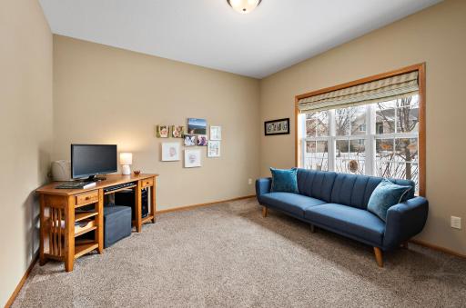 Bright main floor flex space with large windows overlook front yard.