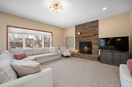 This main level great room will become your favorite spot! The big windows flood this space with light, the floor to ceiling stone gas FP makes for cozy winter nights.