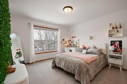 Upper level bedroom 2 overlooking backyard and mature trees!