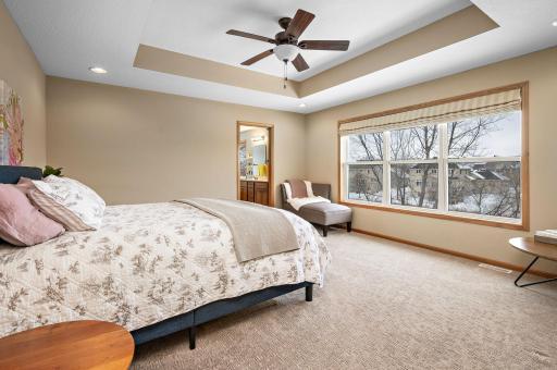 A serene primary bedroom - flooded with natural light with plenty of room for king suite furniture!