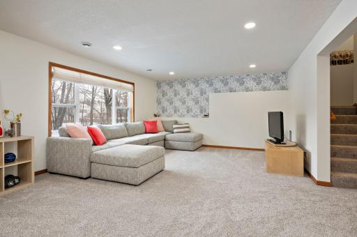 See this in person - a grand sized lower level family room! Walks out to flat backyard.