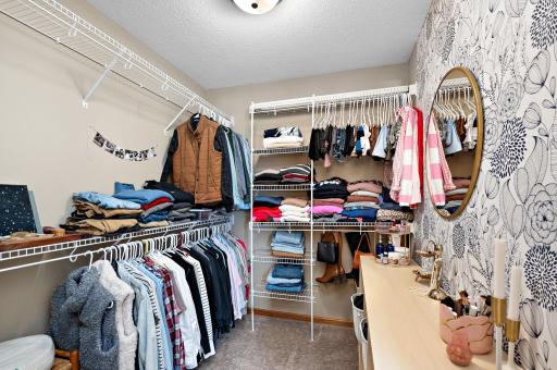 Large primary walk in closet with dressing area.