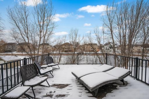 This maintenance free deck has such great views - pond, mature trees - spring will return! Picture yourself here minus the snow....