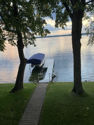 Peaceful shoreline setting offers panoramic lake views, mature trees,and easy access to the water.