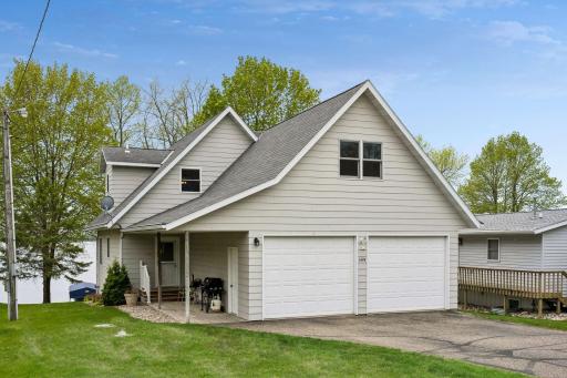 Beautifully maintained year-round home with an attached heated 2-car garage, in-ground sprinkler system, and paved road access.