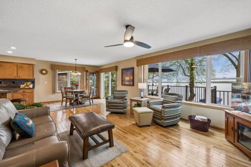 Walls of windows fill the living room with natural light while showcasing the beauty of the lake beyond.
