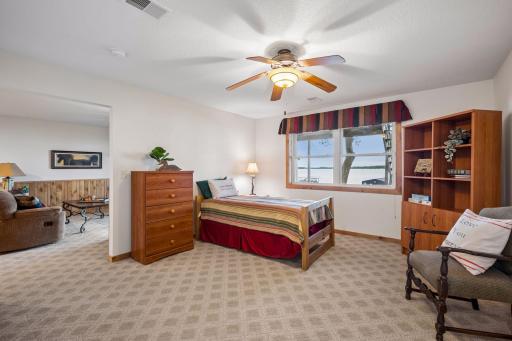 The walk-out lower-level sleeping area features lake views and easy access to the family room and paver patio.