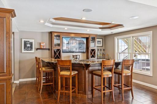 Lower-level custom wet bar is sure to impress