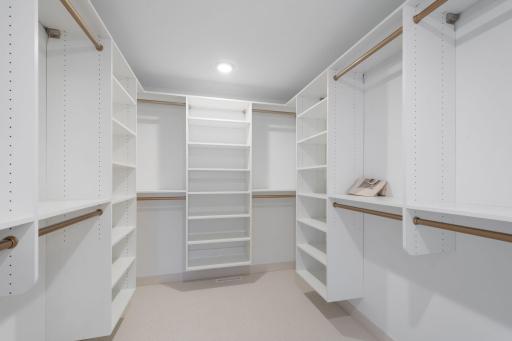 Primary bedroom walk-in closet with built-ins