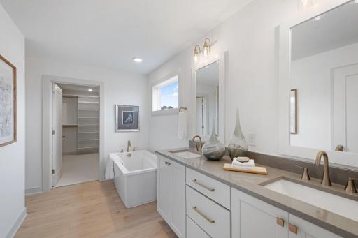 Primary bedroom ensuite with freestanding soaker tub, HUGE fully tiled walk-in shower and dual vanities