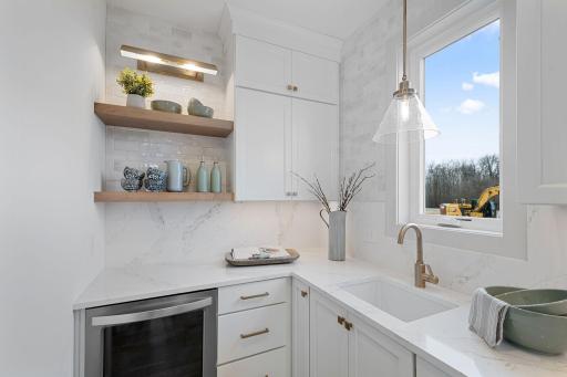 Prep kitchen with additional sink and beverage fridge