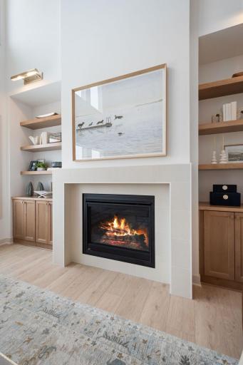 Tile gas fireplace in 2 story vaulted great room with built-ins