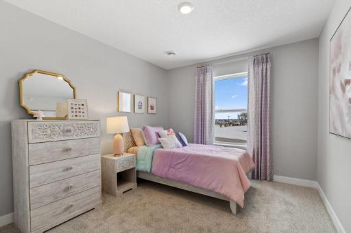 Spacious bedroom #3 with lots of natural light. Photo is of model home. Colors and options may vary. Ask Sales Agent for details.