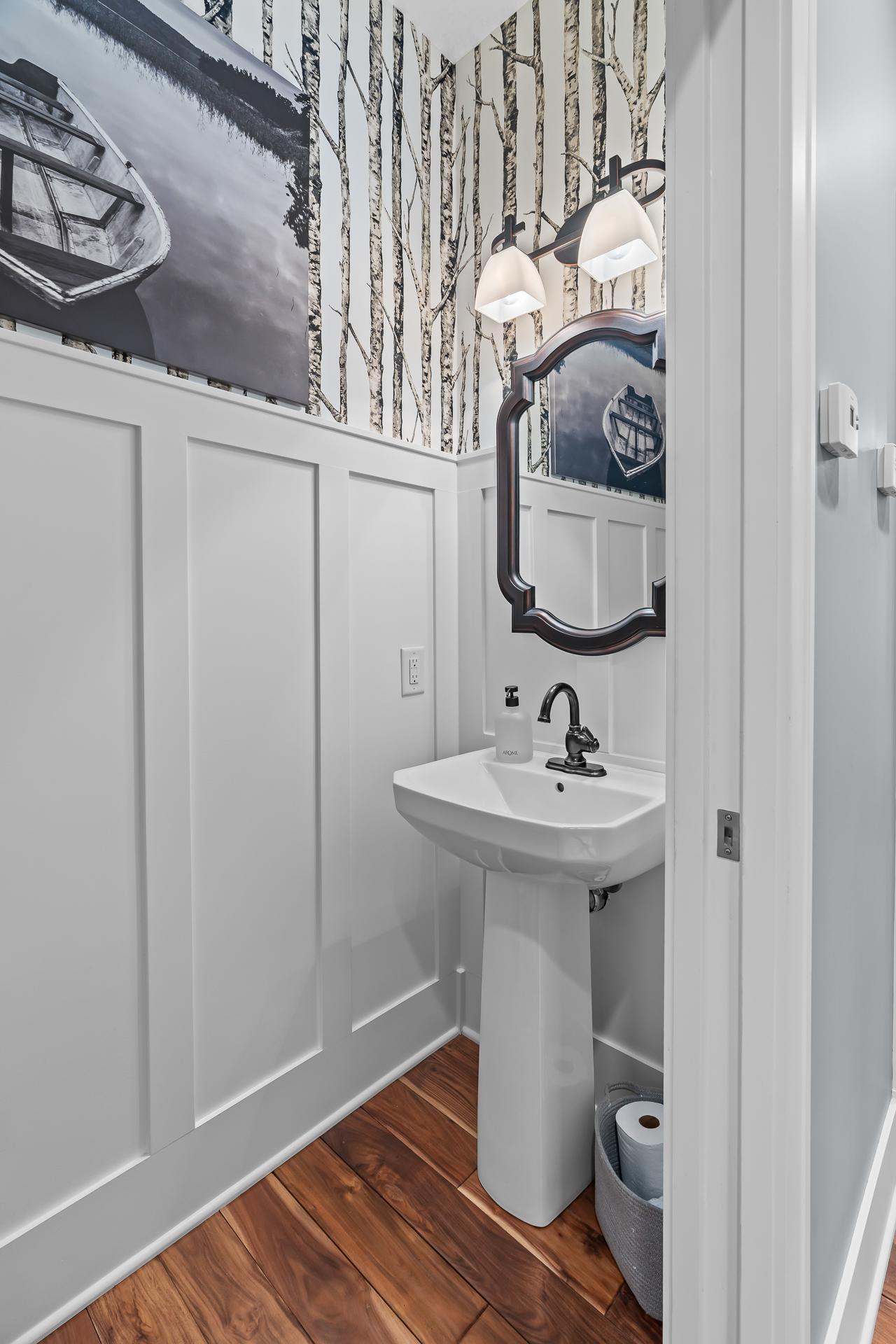 Guest Half Bath with pocket door is located down the hall from the Office.