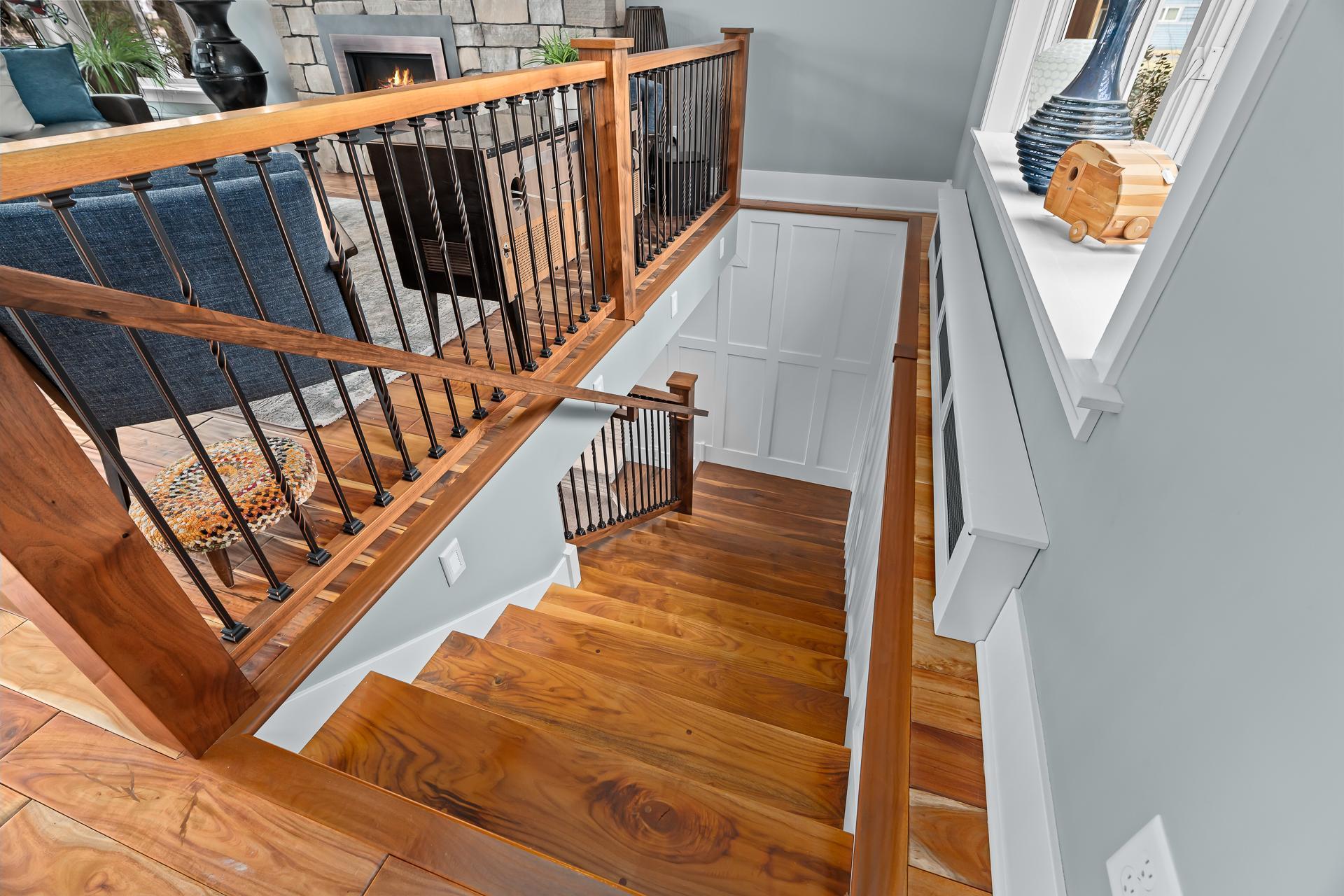 Handcrafted walnut staircase (moved from the center of the home where it obstructed the view).