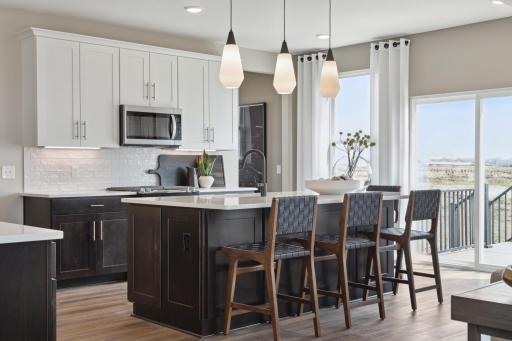 Ivy Model in Rosemount - Expansive island with quartz surface offers additional prep space, bar seating, and a stylish centerpiece to your new kitchen.