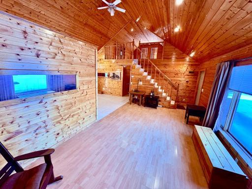 Living room with vaulted ceilings and loft