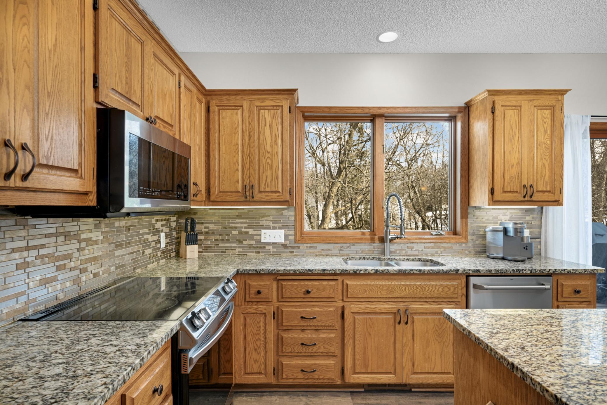 Kitchen window overlooking private back yard