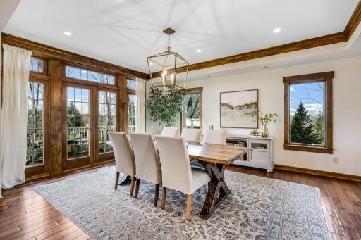 Open to both the kitchen and great room with crown molding and multiple windows + glass doors.