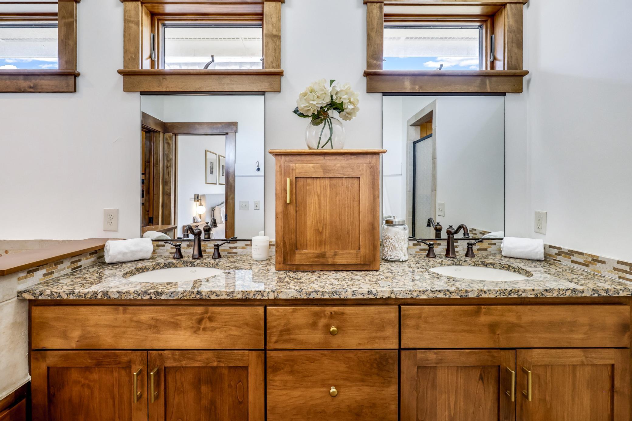 Dual sinks Granite countertops. Custom hardwood built-ins.