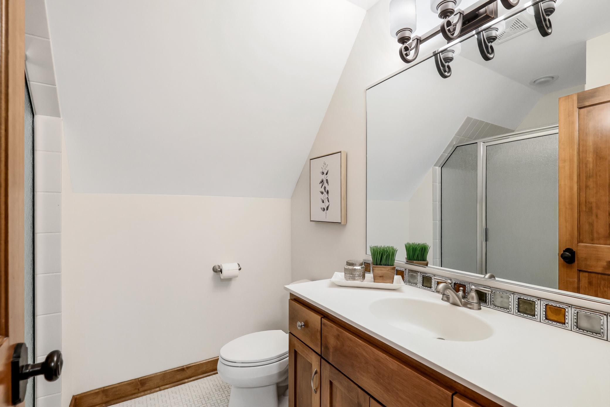 ¾ Bath: tile floors and tile shower surround.