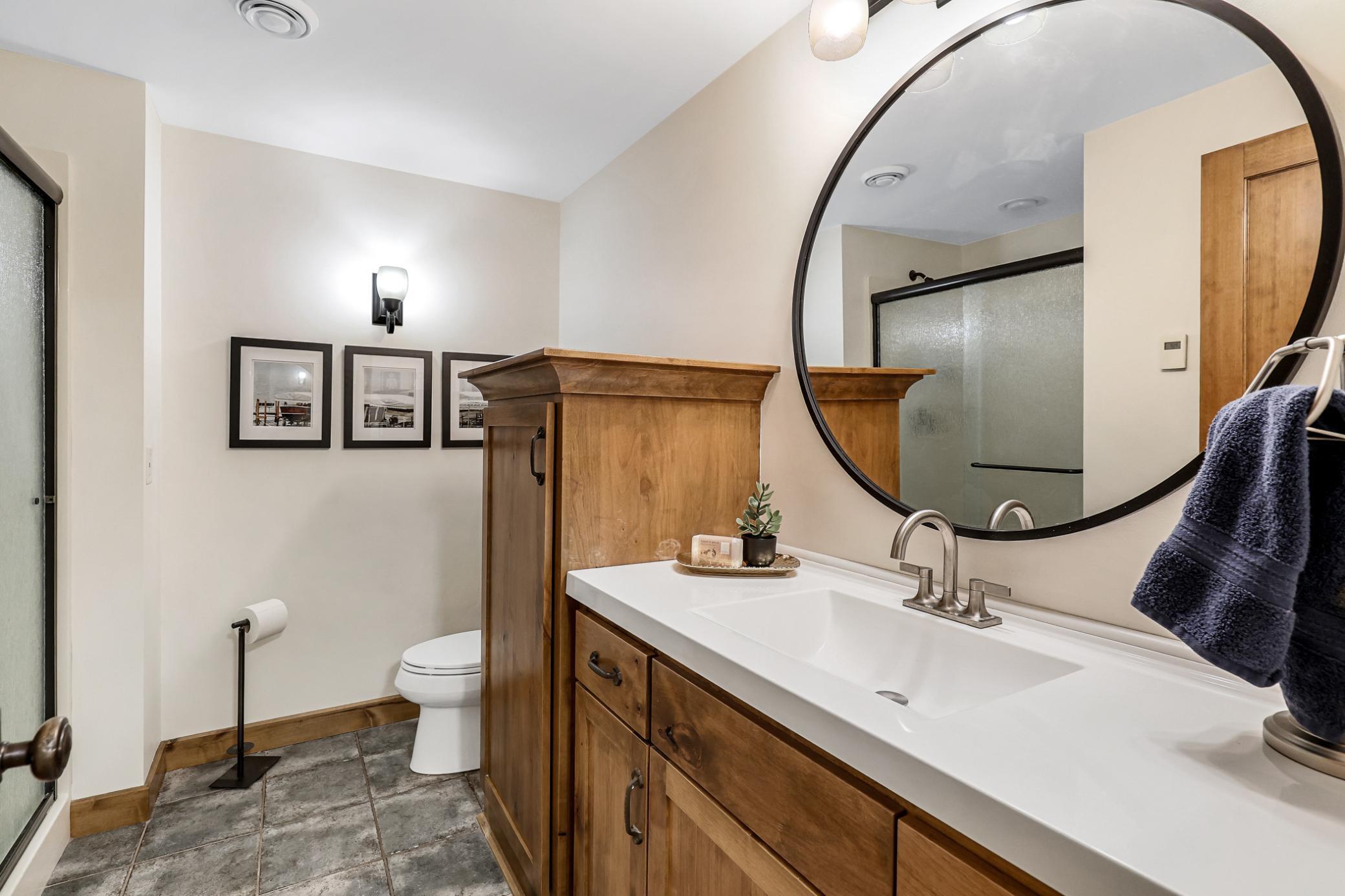 ¾ bathroom: large vanity and tile floors.