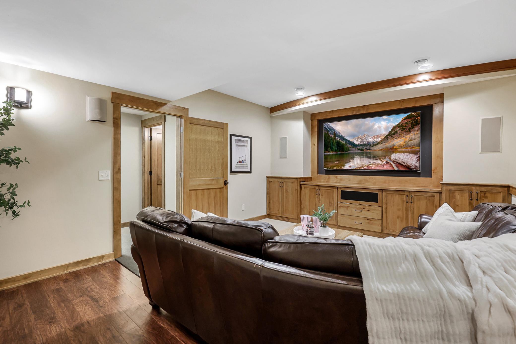 Space for plenty of seating, a media wall with built-in storage & a design which works with a large screened tv or projector set-up, plus built-in surround sound speakers.