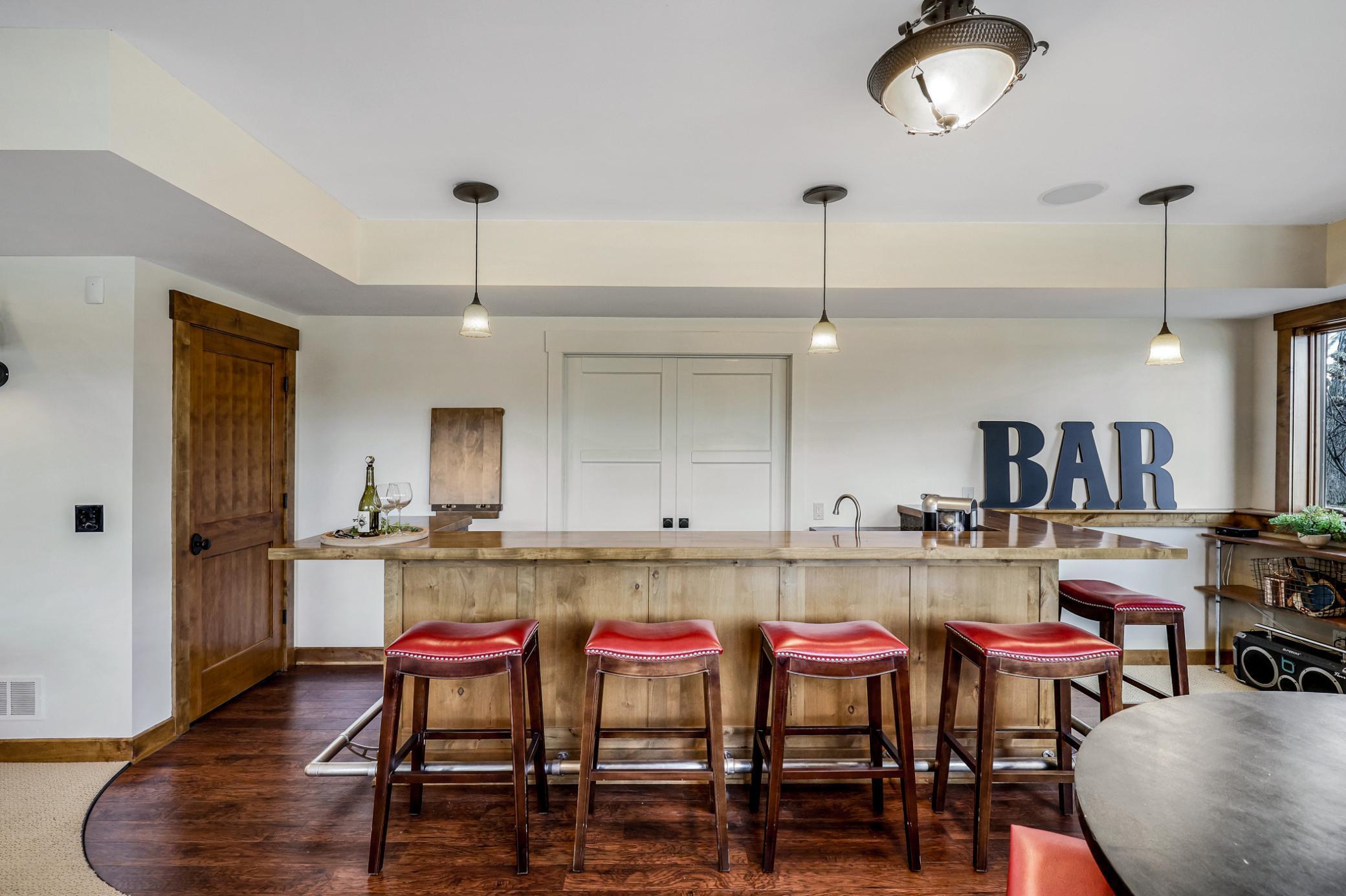 New, enameled French doors which connect the bar area to the theater room.