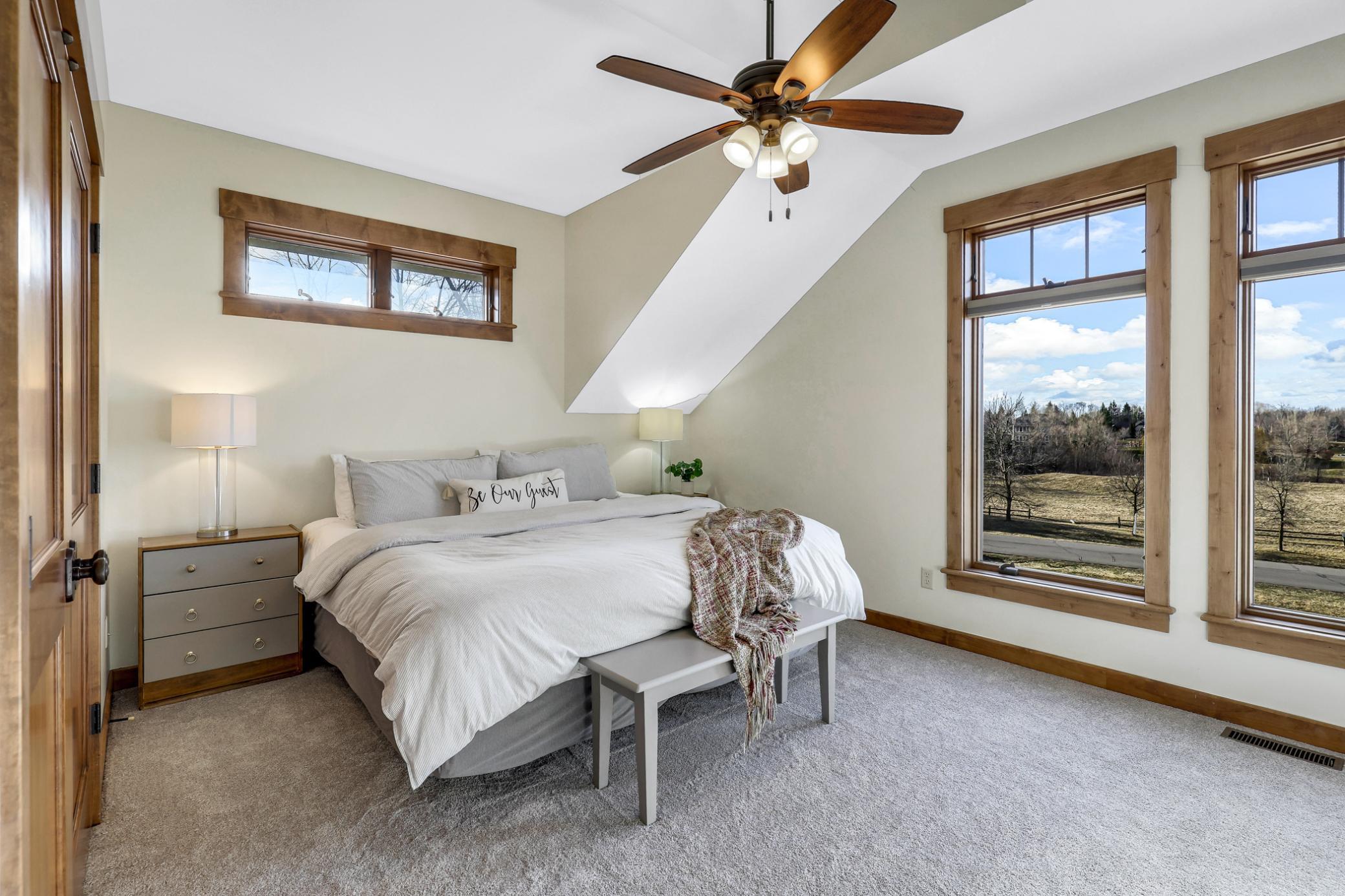 Side by side, the bedrooms are mirror images of each other, both spacious with vaulted ceilings, new carpet, large closets and oversized windows & transoms.